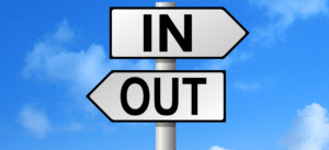 Signpost with arrows labeled 'IN' and 'OUT', representing inbound and outbound directions or strategies.