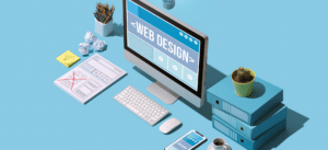 A modern workspace featuring a computer screen displaying 'Web Design', surrounded by design sketches, a smartphone, and office supplies on a blue background