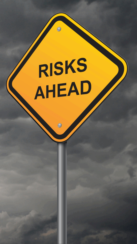 Yellow road sign with the words “Risks Ahead” against a cloudy, stormy sky, representing the potential dangers and warnings associated with AI-generated content.