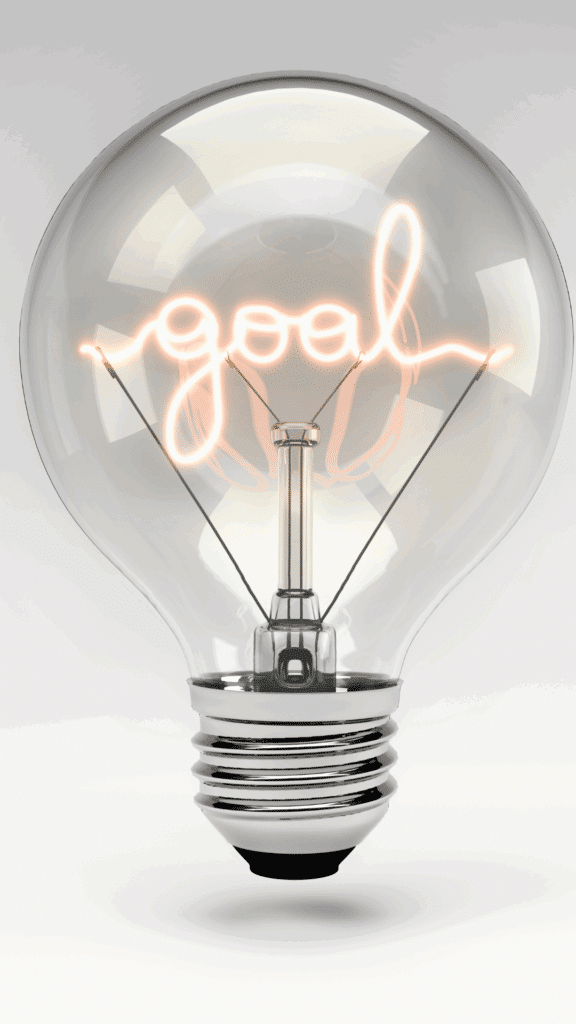 A bright, clear lightbulb with the word “goal” formed by the glowing filament, symbolizing clarity and focus in setting business objectives.