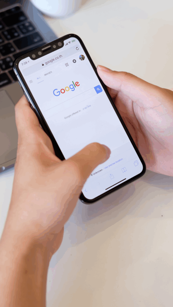 Person holding a smartphone displaying the Google search homepage, emphasizing the importance of Google My Business for Niagara businesses.