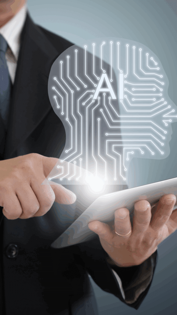 Close-up of a person in a suit using a tablet, with a glowing outline of a human head filled with circuit patterns and the letters “AI,” symbolizing human oversight of artificial intelligence.