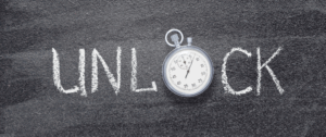 High-resolution photo of a classic silver stopwatch resting on a dark chalkboard background, with partial white chalk writing visible. The image symbolizes timing, precision, and strategic decision-making in digital marketing.