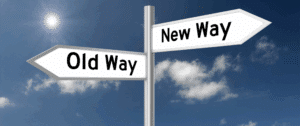 Photo of two intersecting street signs against a blue sky with clouds. One sign reads “Old Way” and the other reads “New Way,” representing the shift from traditional to AI-driven marketing strategies.