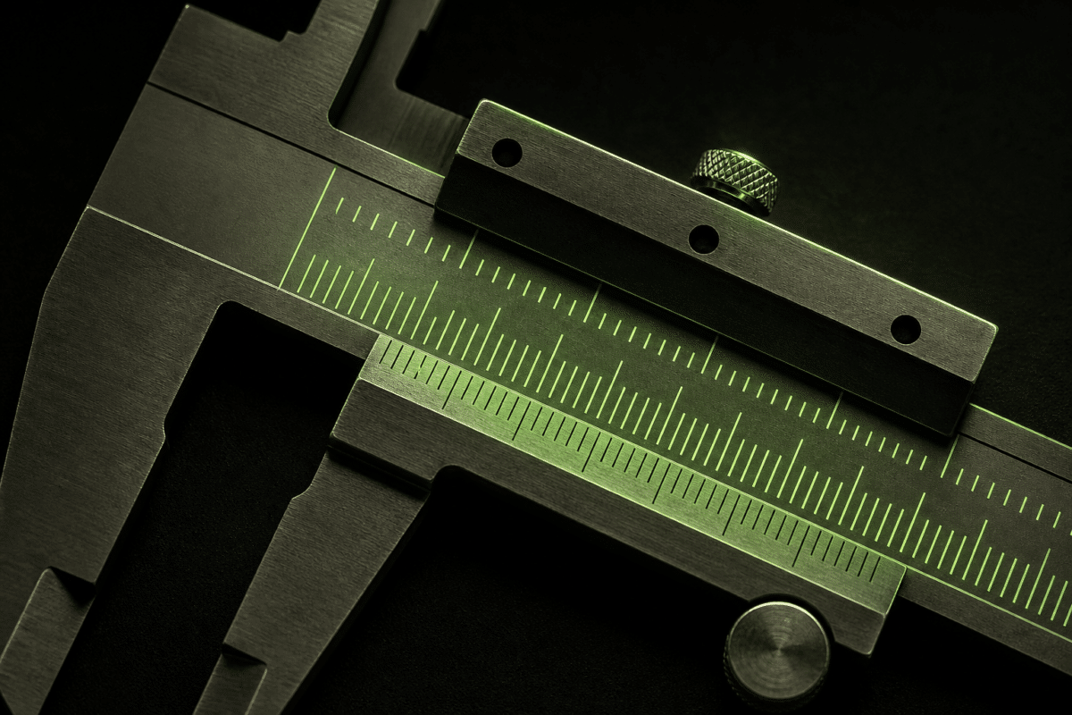 Close-up of a vernier caliper with a green measurement scale.